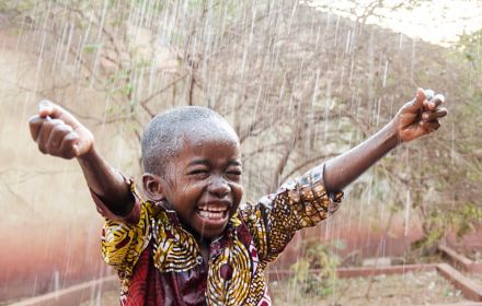 Happy child in a rain