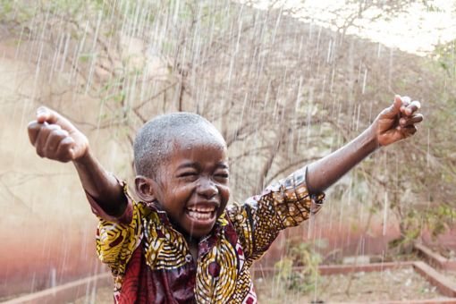 Happy child in a rain
