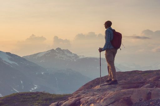 Hiker looking over mountains at sunrise