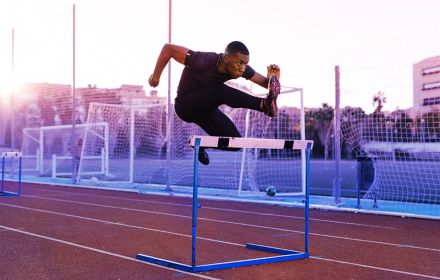 Man jumping over a hurdle