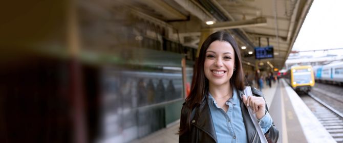 Infrastructure, Assets & Places - a smiling woman on a Melbourne train station platform