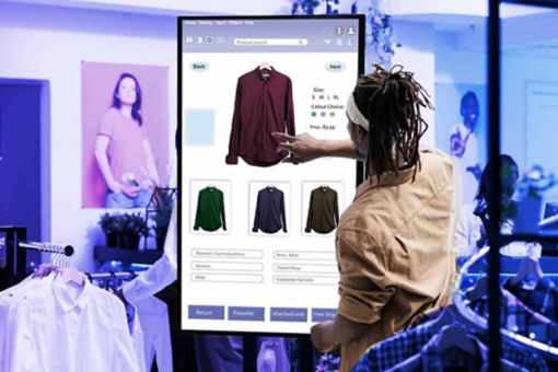 Woman using touchscreen in clothing store