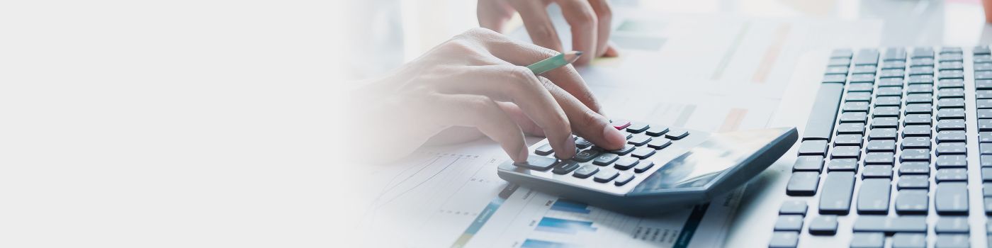 Person using calculator and keyboard