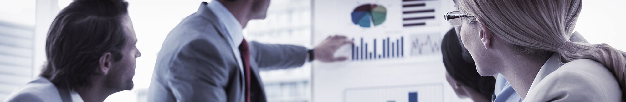 Four people looking at graphs in a business meeting