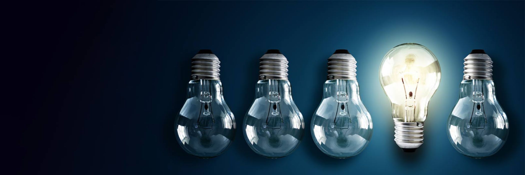 Illuminated light bulb in a row of dim ones concept for creativity, innovation and solution