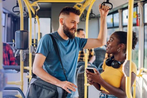 Two people chatting on a bus