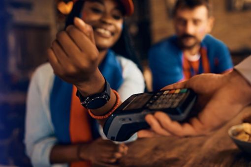 Woman paying at till with smartwatch