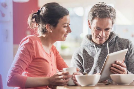 Two people calculating taxes at home