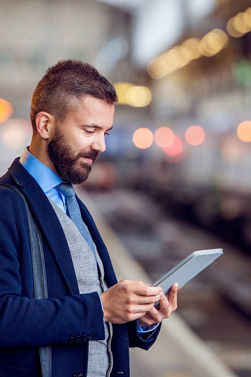 Man using tablet on train platform