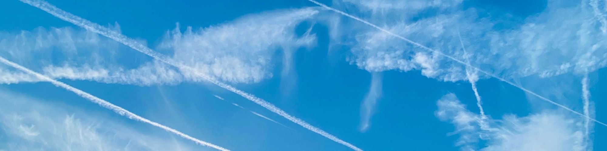 Contrails clouds against blue sky texture background