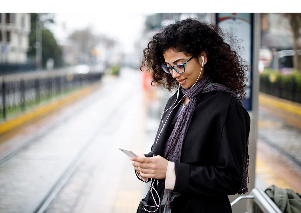 Smiling woman using mobile phone - Customer Centric Strategy