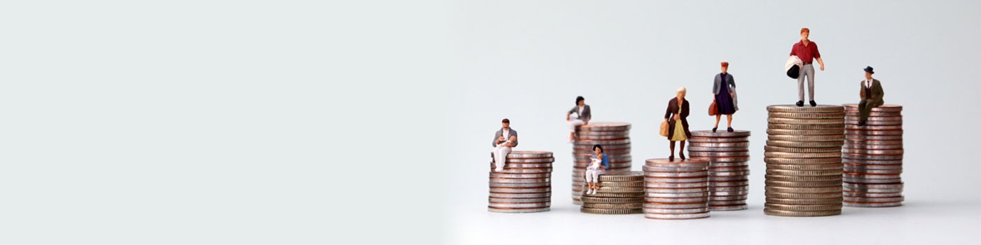 Variety of miniature people sitting on stacks of coins