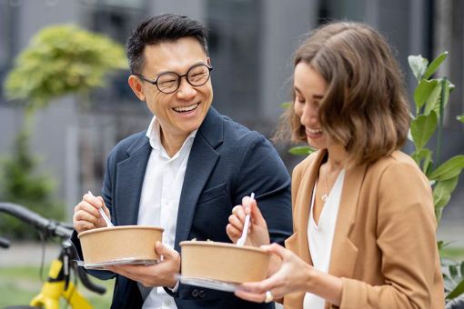 Colleagues having lunch outdoors