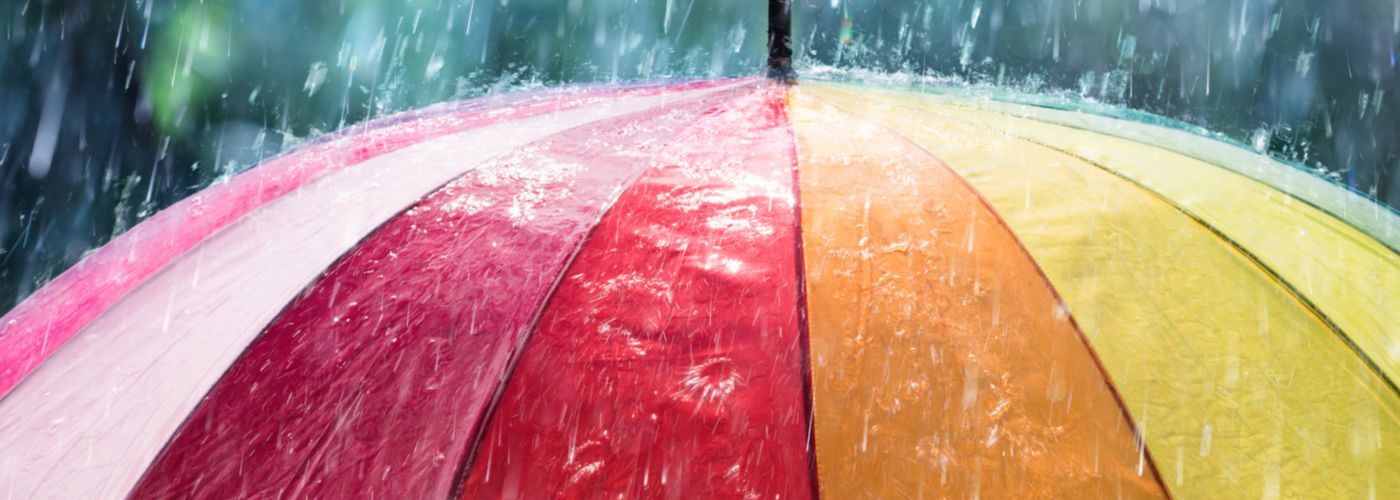 Rainbow umbrella in rain