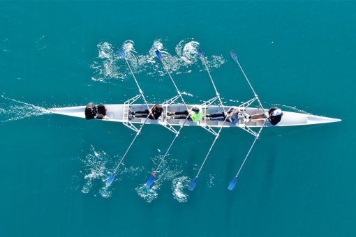 Racing boat and team seen from above