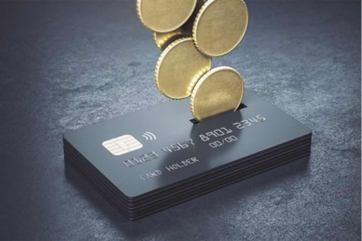 Cashback loyalty programme concept with metal coins bound for a stack of black credit cards on abstract dark surface. 3D rendering