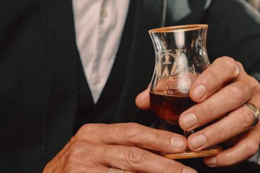 Man holding a whiskey glass