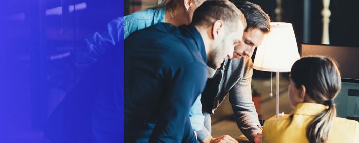 Group of 4 people working together in an office