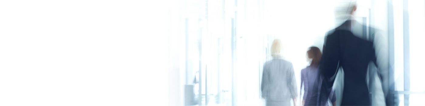 Abstract, blurred business people walking