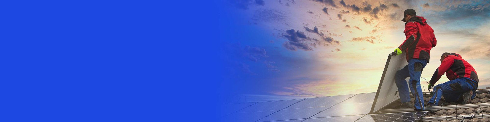 Two engineers working on solar panels on a roof