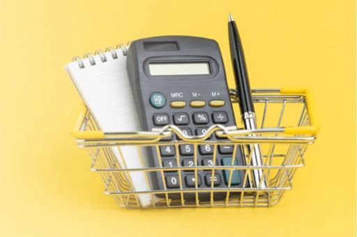 Calculator, notepad and pen in mini shopping trolley