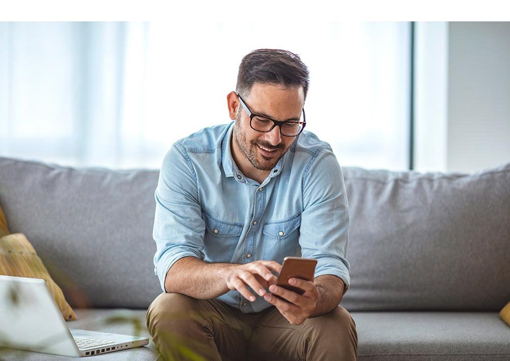 Smilng man using mobile phone - Voice of Customer