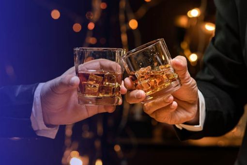 Cheers with whiskey glasses