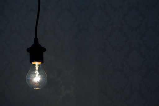 Illuminated light bulb hanging from the ceiling