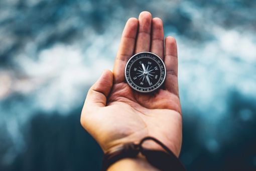 hand holding compass