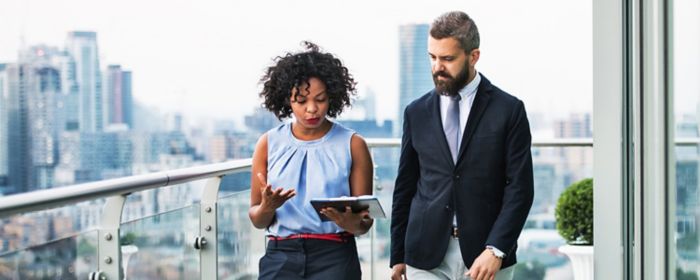 man and woman looking at notepad