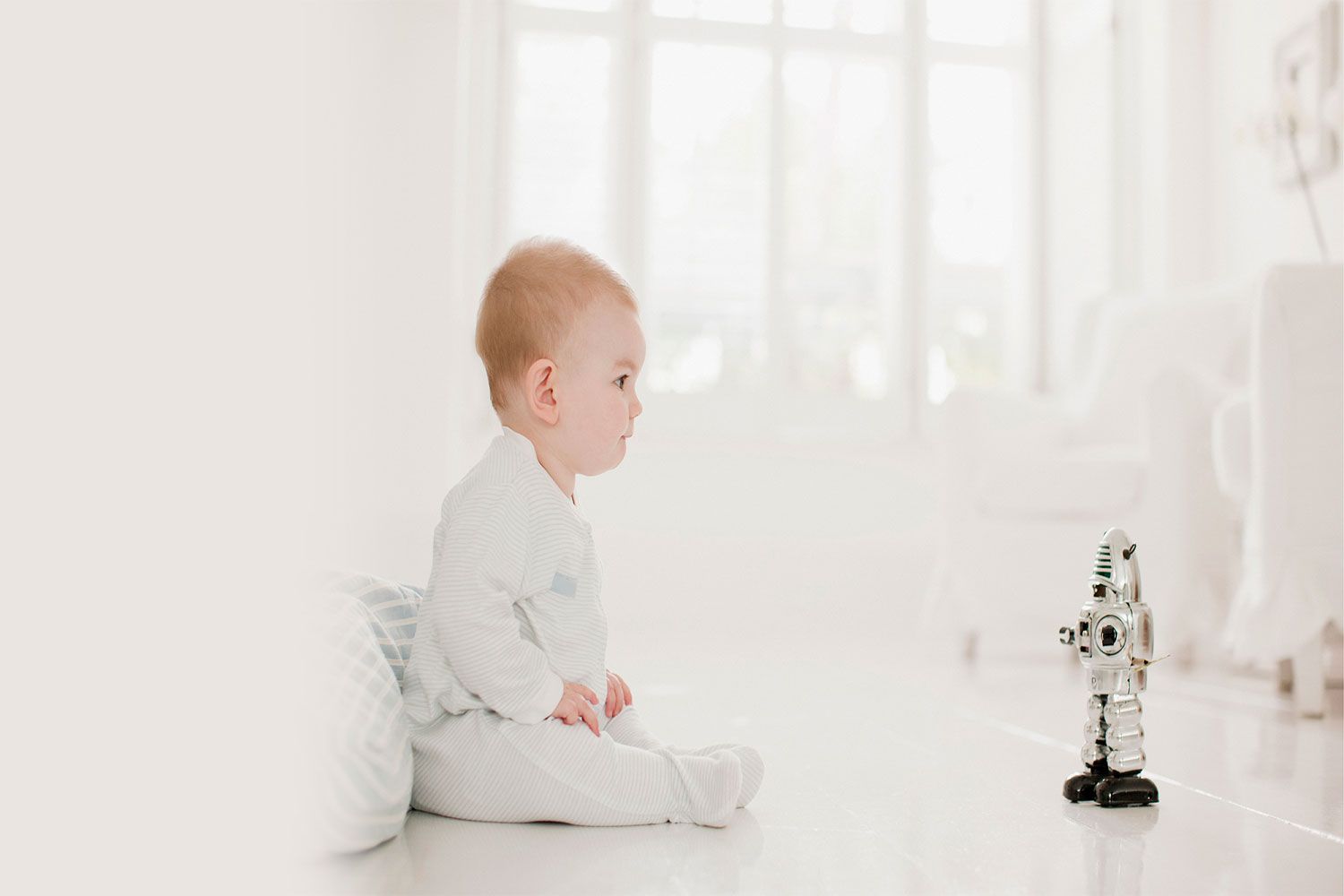 Bebê brincando com um robô de brinquedo