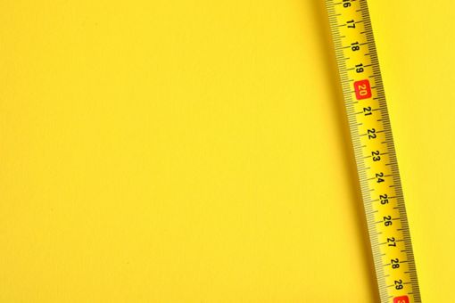 measuring tape on yellow background