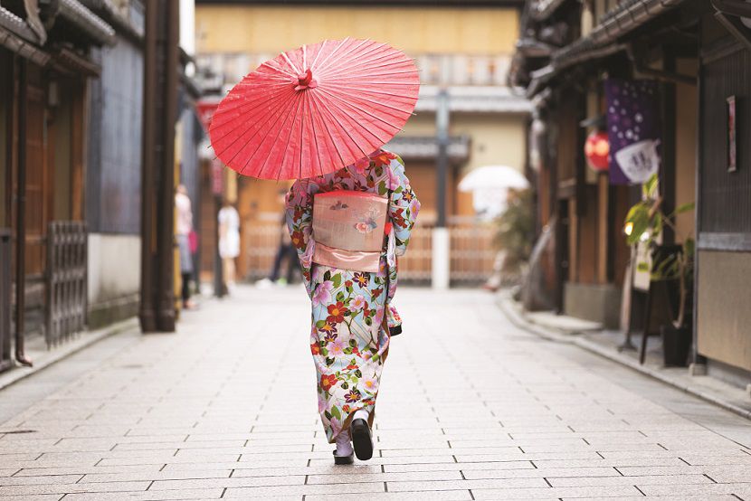 Japanese woman walking with traditional umbrella