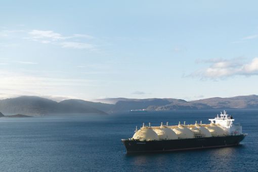 Sailing tank ship and mountain range