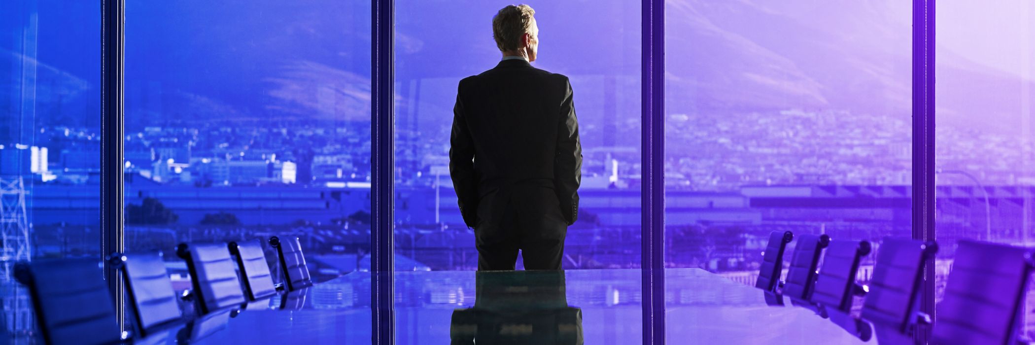 Business Person looking outside a window
