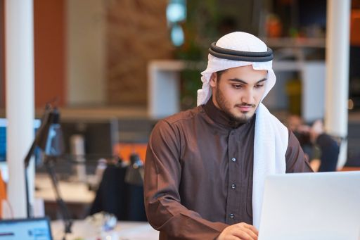Kuwaiti Man working with laptop