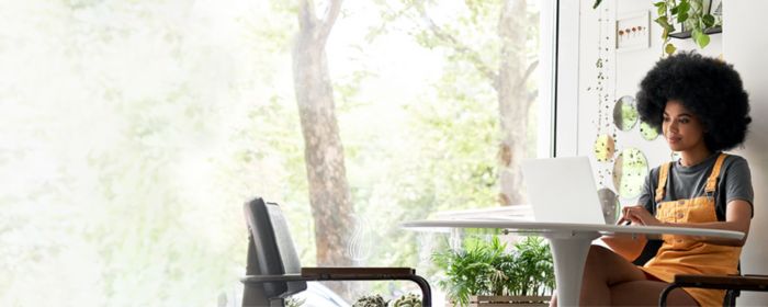 lady-working-on-laptop-with-plants-around-her-banner