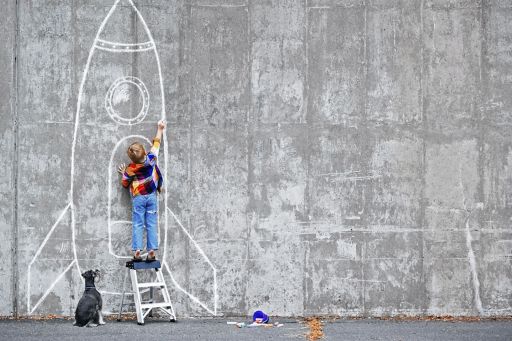 Little boy drawing a rocket