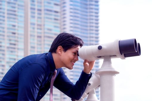 looking into telescope