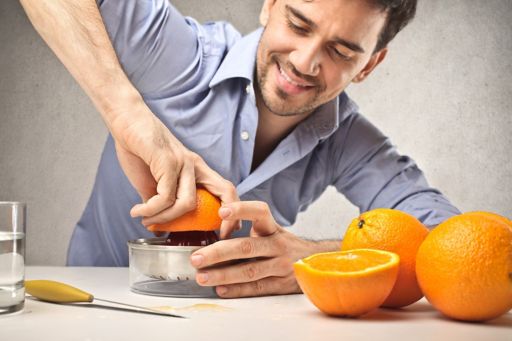 Man squeezing orange
