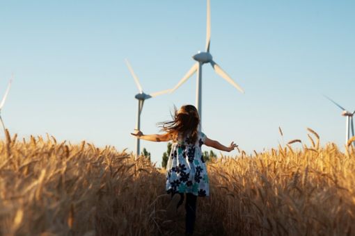 Girl running through field