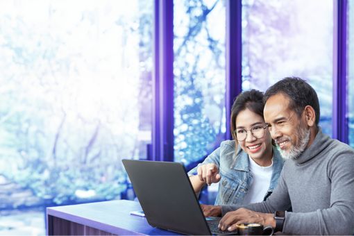 man and woman looking at a laptop