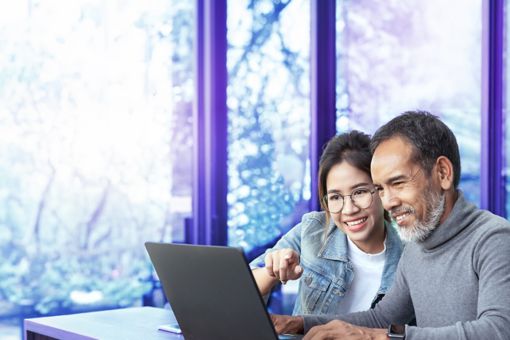 Man and woman looking at a laptop