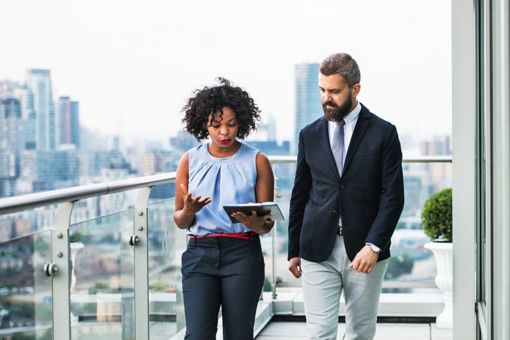 man and woman looking at notepad