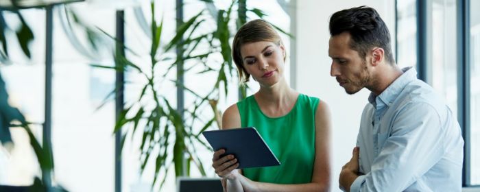 man and woman watching tablet