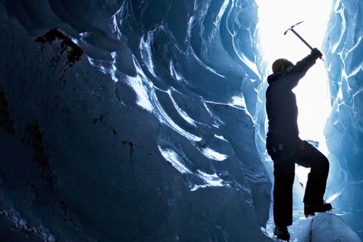 Man exploring glacial cave