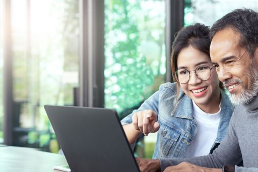 Man and a girl using laptop