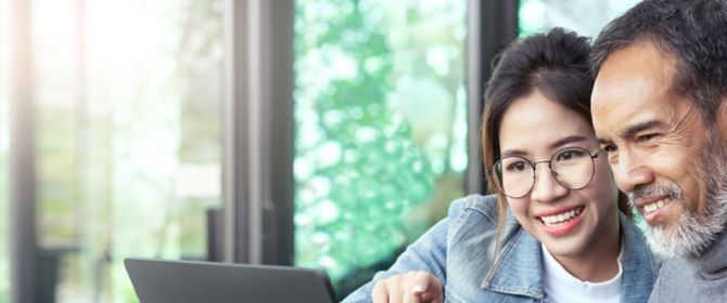 Man and a girl using laptop