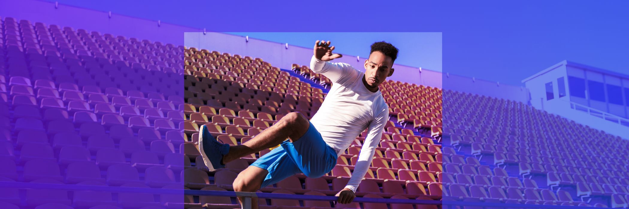 man jumping over ramp in stadium