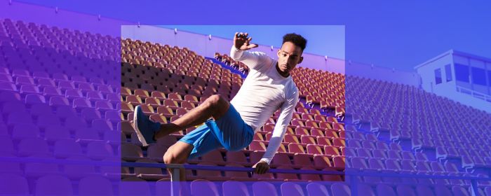man jumping over ramp in stadium